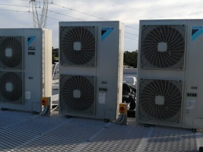 Four Daikin VRV outdoor air conditioning units installed on the rooftop of Rouse Hill warehouse office